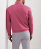 Pink quarter-zip terry pullover worn with light gray pants, back view