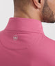 Pink quarter-zip terry pullover with stand collar and small circular neck logo