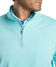 Men's quarter-zip stretch pullover close-up in light teal with zip placket and collar.