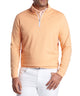 Peach-orange quarter-zip terry pullover worn with white pants, front view