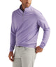 Purple stretch quarter-zip pullover on model with half-zip collar and long sleeves.
