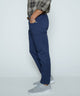 Dark blue stretch denim jeans shown from the side with belt loops and five pockets.