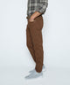 Brown stretch denim jeans with belt loops and five-pocket styling, side view.
