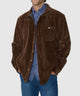 Brown knit corded shirt jacket worn by model, with chest pocket and plaid shirt collar